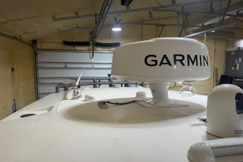 Slide: The Image of 2024 Solace 30HCS boat with Garmin radar in a garage setting. - 35