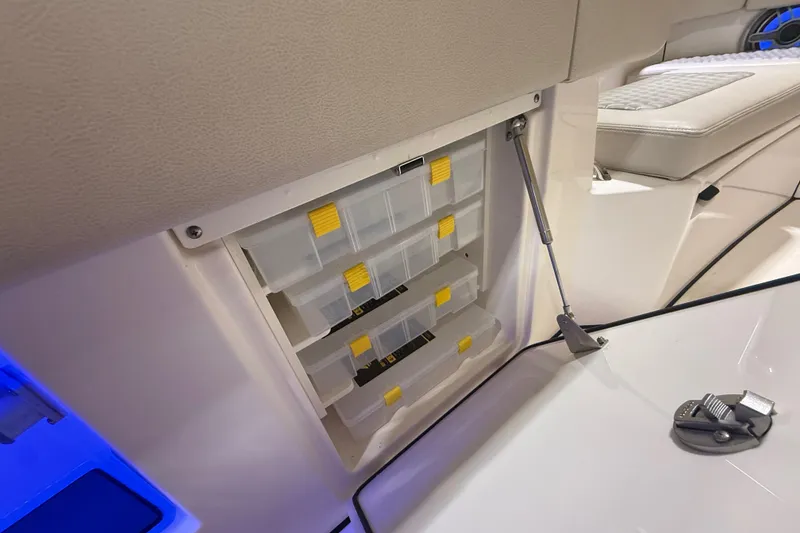 Slide: The Image of Storage compartment with tackle boxes in 2024 Solace 30HCS boat interior. - 37