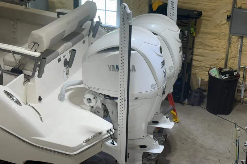 Slide: The Image of 2024 Solace 30HCS boat with dual Yamaha outboard engines in a garage setting. - 4