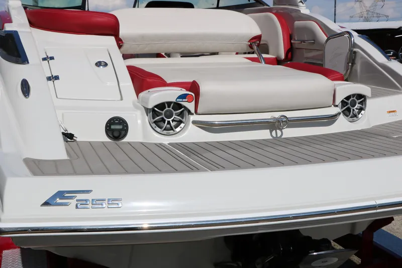 Slide: The Image of 2022 Crownline Eclipse E255 boat with red and white seating, rear speakers, and sleek design. - 8