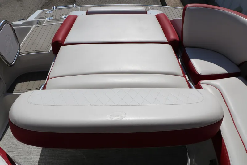 Slide: The Image of 2022 Crownline Eclipse E255 boat interior with red and white cushioned seating. - 22