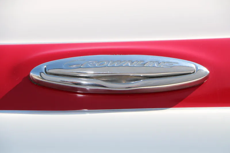 Slide: The Image of Chrome "Crownline" emblem on a 2022 Eclipse E255 boat, set against a red and white background. - 18