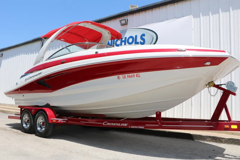 The Image of 2022 Crownline Eclipse E255 boat with red and white design on trailer. - 0