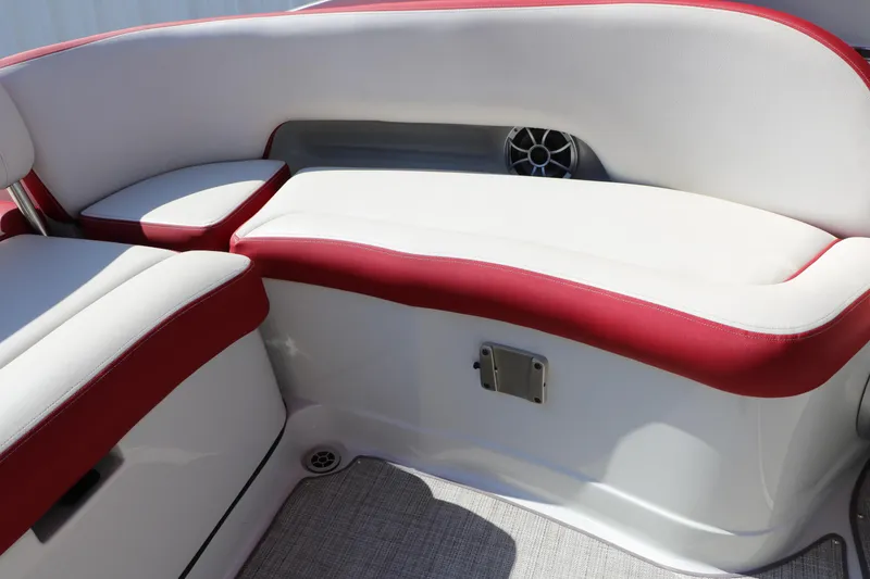 Slide: The Image of 2022 Crownline Eclipse E255 boat interior with red and white seating and speaker. - 41