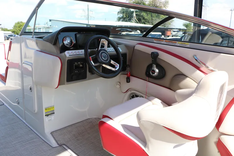 Slide: The Image of 2022 Crownline Eclipse E255 boat interior with modern steering and controls. - 28