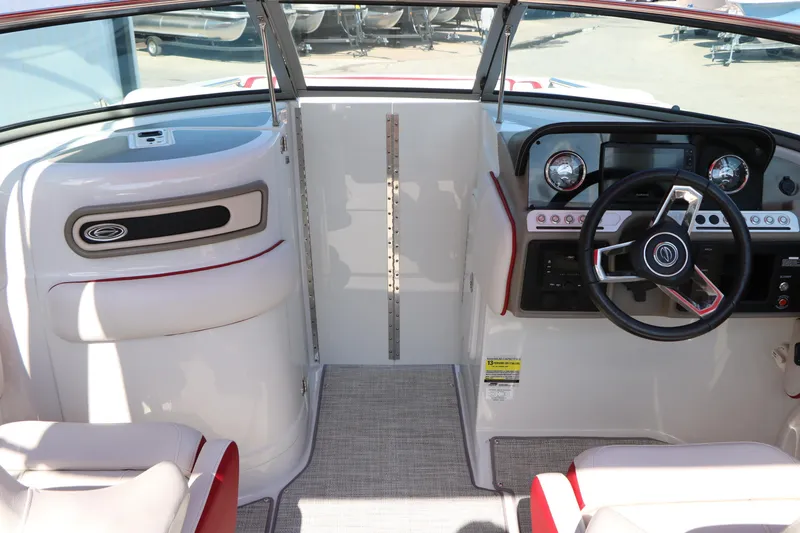 Slide: The Image of 2022 Crownline Eclipse E255 boat interior with modern dashboard and steering wheel. - 45