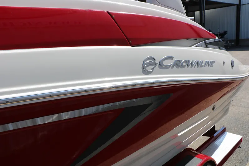 Slide: The Image of 2022 Crownline Eclipse E255 boat with sleek red and white design. - 19