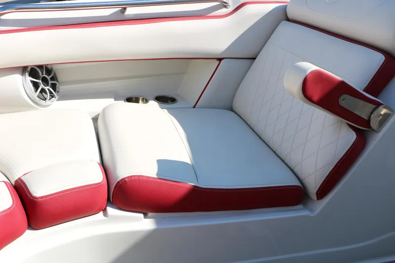 Slide: The Image of 2022 Crownline Eclipse E255 boat interior with red and white seating and speaker. - 49