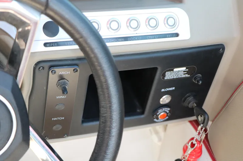 Slide: The Image of Dashboard controls of a 2022 Crownline Eclipse E255 boat, featuring switches and ignition. - 47