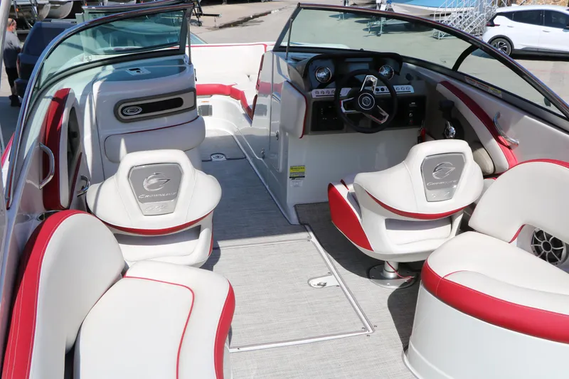 Slide: The Image of 2022 Crownline Eclipse E255 boat interior with red and white seating, modern dashboard, and spacious layout. - 23