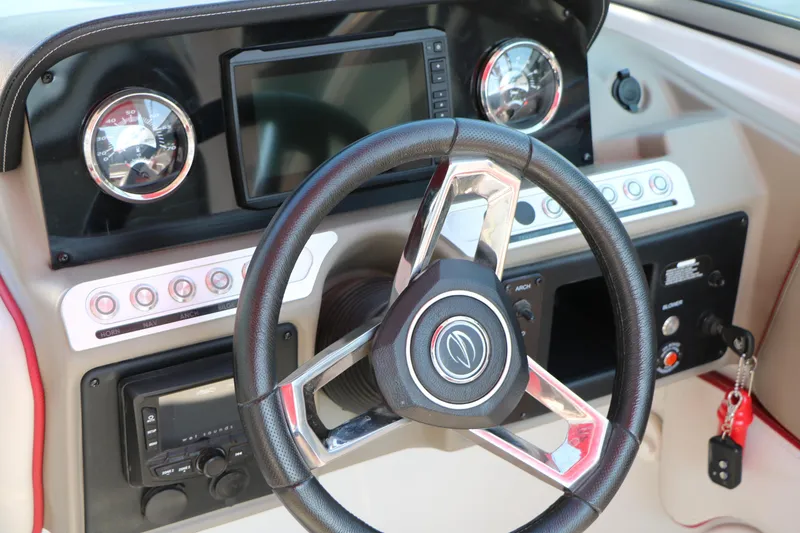 Slide: The Image of 2022 Crownline Eclipse E255 dashboard with steering wheel and control panel. - 33