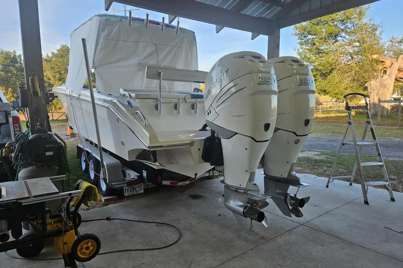 Slide: The Image of 2003 Dakota 36 CC boat with twin Mercury 350 engines under a shelter. - 17