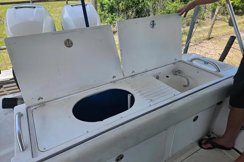 Slide: The Image of 2003 Dakota 36 CC boat with open storage compartments and sink on deck. - 13