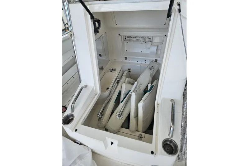 Slide: The Image of Storage compartment of a 2003 Dakota 36 CC boat with cushions and equipment. - 34