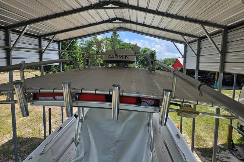 Slide: The Image of 2003 Dakota 36 CC boat under metal shelter with Garmin equipment visible. - 31