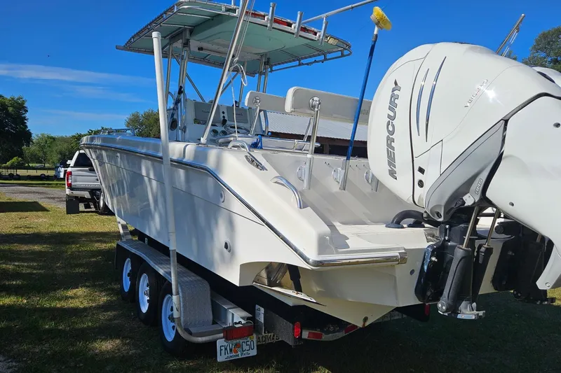 Slide: The Image of 2003 Dakota 36 CC boat with Mercury engine on trailer, parked outdoors. - 27