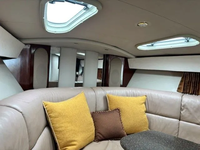 Slide: The Image of Interior of a 2003 Formula 400 Super Sport with beige upholstery and yellow cushions. - 13