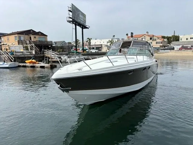Slide: The Image of A sleek motor yacht with a gray hull and white deck, docked in calm harbor waters. - 4