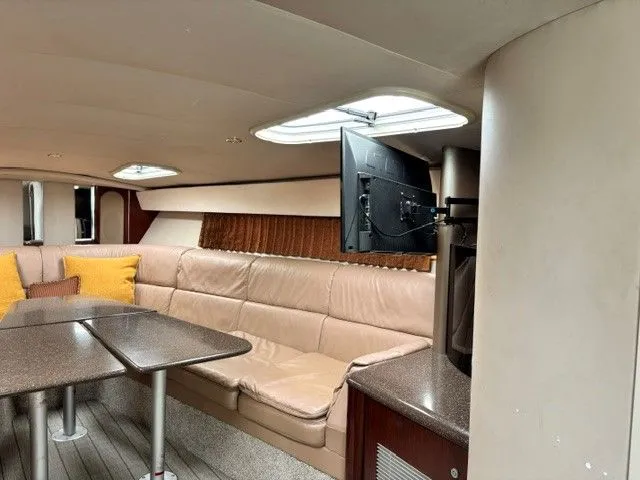 Slide: The Image of Interior of a 2003 Formula 400 Super Sport with beige leather sofa, table, and TV. - 11