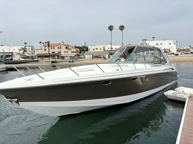 Slide: The Image of A 2003 Formula 400 Super Sport is docked in the water. - 2