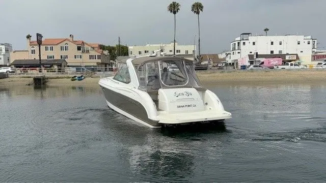 Slide: The Image of A white motor yacht cruises on calm water in an urban harbor area. - 18