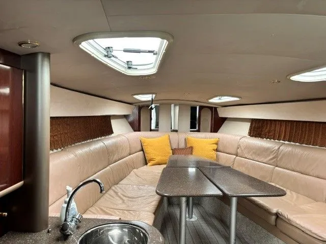 Slide: The Image of Interior of a 2003 Formula 400 Super Sport with beige leather seating and dining table. - 9