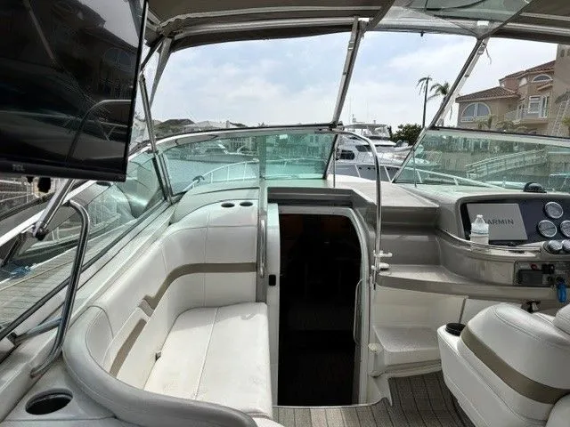 Slide: The Image of The cockpit of a 2003 Formula 400 Super Sport with white seating and a Garmin navigation system. - 7