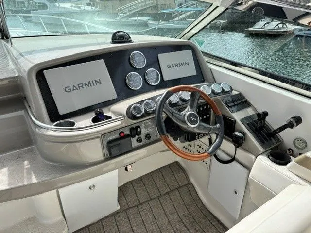 Slide: The Image of The cockpit of a 2003 Formula 400 Super Sport with Garmin screens and a wooden steering wheel. - 8
