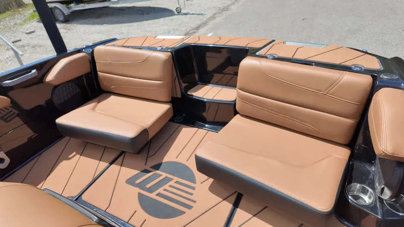 Slide: The Image of The image shows the interior of a 2025 Malibu TXi with brown leather seats and stylish flooring. - 20