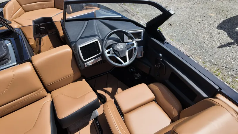 Slide: The Image of The image shows the cockpit of a 2025 Malibu TXi with brown leather seats and modern instruments. - 11
