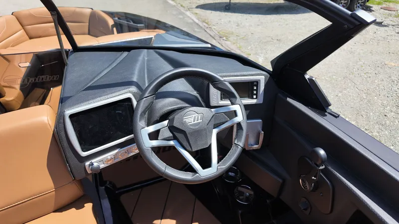 Slide: The Image of The image shows the cockpit of a 2025 Malibu TXi with a modern steering wheel and digital displays. - 12