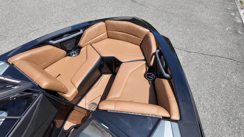 Slide: The Image of The image shows the bow of a 2025 Malibu TXi with brown leather seating. - 15