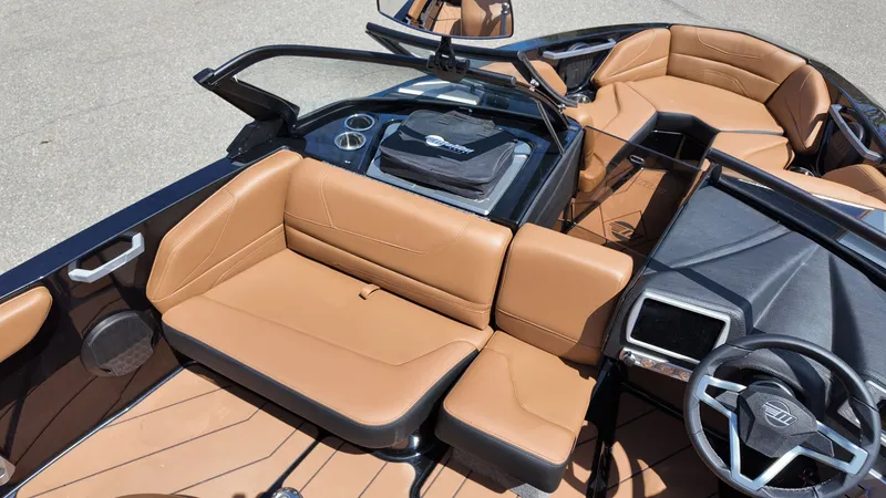 Slide: The Image of The image shows the cockpit of a 2025 Malibu TXi with brown leather seats and a modern dashboard. - 13