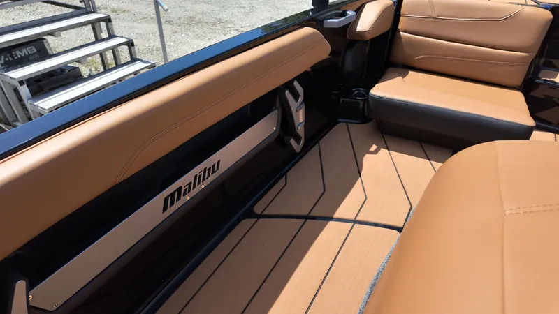 Slide: The Image of The image shows the interior of a 2025 Malibu TXi with brown leather seating. - 17