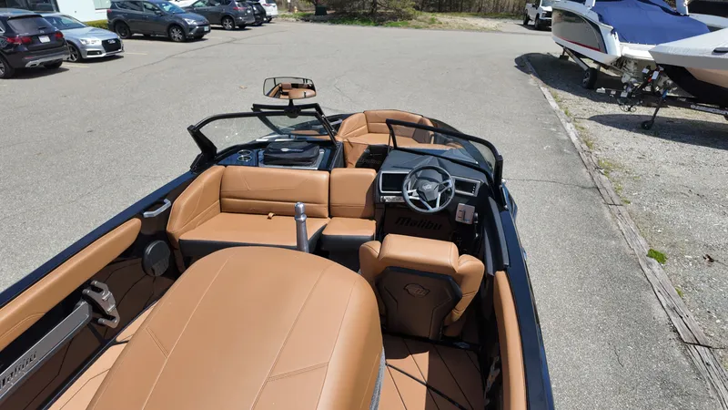 Slide: The Image of The image shows the interior of a 2025 Malibu TXi with brown leather seats and a modern dashboard. - 9
