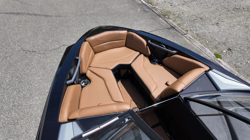 Slide: The Image of The image shows the bow of a 2025 Malibu TXi with brown leather seating. - 14