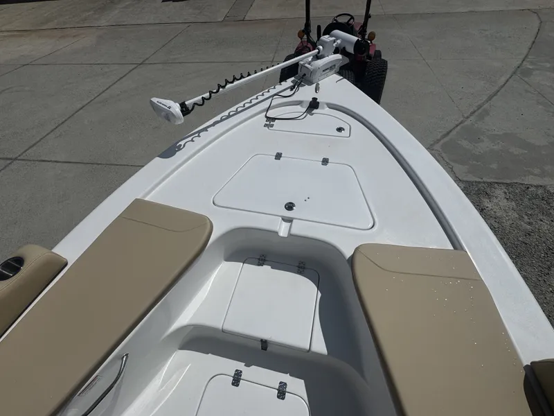 Slide: The Image of The image shows the deck of a Sea Pro 230 DLX boat with beige seats and a motor. - 10