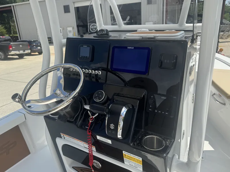 Slide: The Image of The image shows the helm of a Sea Pro 230 DLX boat with modern instruments. - 3