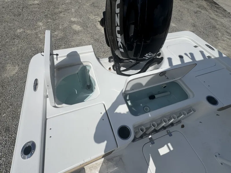 Slide: The Image of The image shows the stern of a Sea Pro 230 DLX boat with a Suzuki outboard motor and multiple storage compartments. - 8