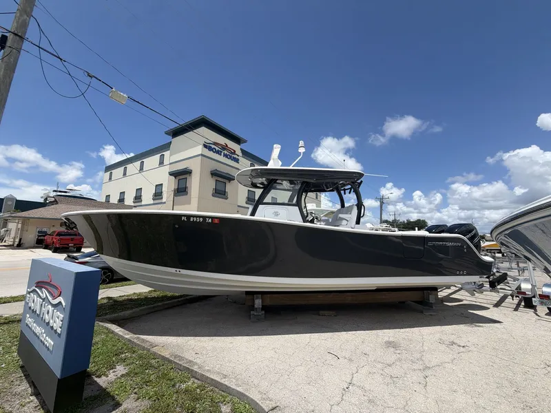 Slide: The Image of A gray 2021 Sportsman Open 322 Center Console boat is parked on a lot in front of a building. - 9