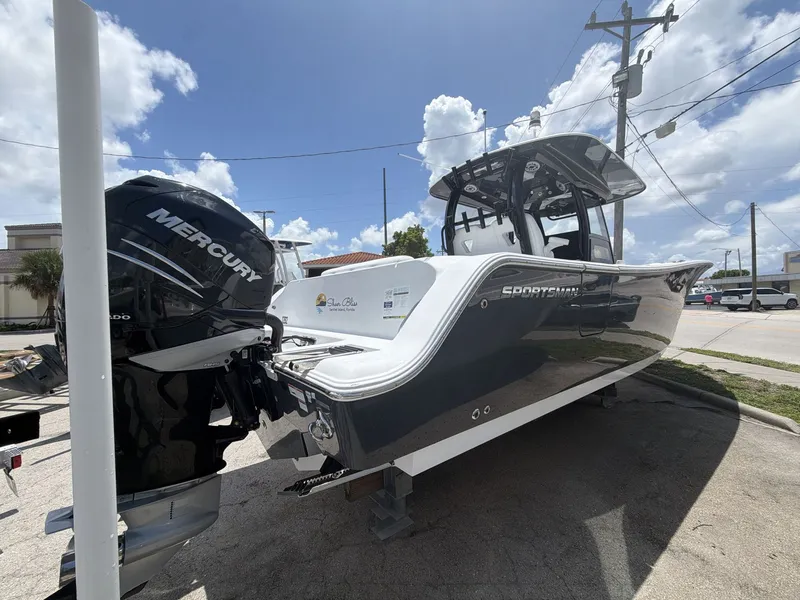 Slide: The Image of A 2021 Sportsman Open 322 Center Console boat with a Mercury outboard motor, parked on a trailer. - 16