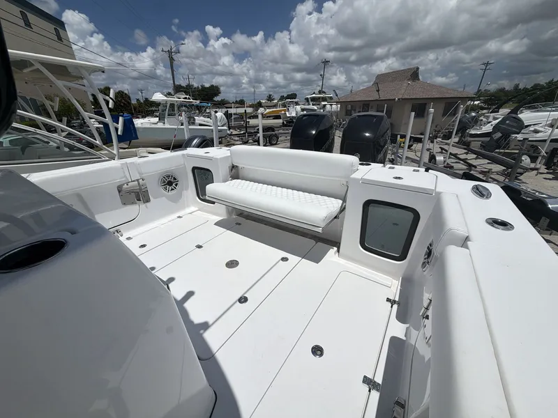 Slide: The Image of The image shows the spacious aft deck of a 2021 Sportsman Open 322 Center Console boat. - 13