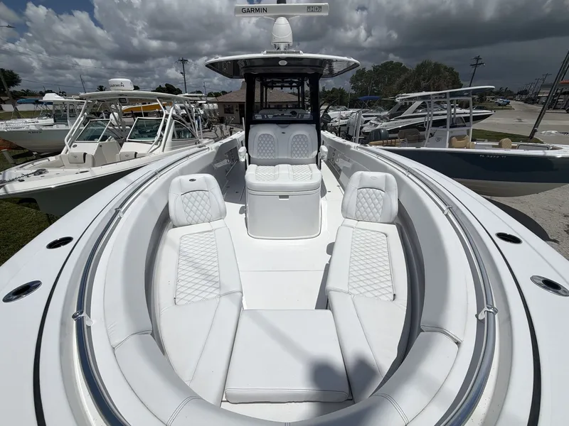 Slide: The Image of A 2021 Sportsman Open 322 Center Console boat with a spacious deck and luxurious seating. - 19