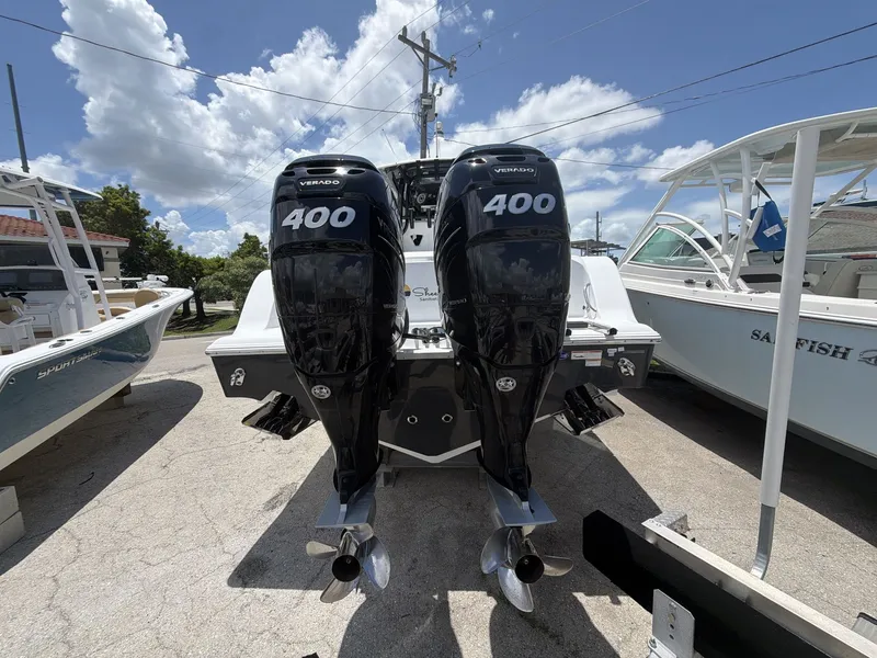 Slide: The Image of Two powerful outboard engines on a 2021 Sportsman Open 322 Center Console boat. - 18