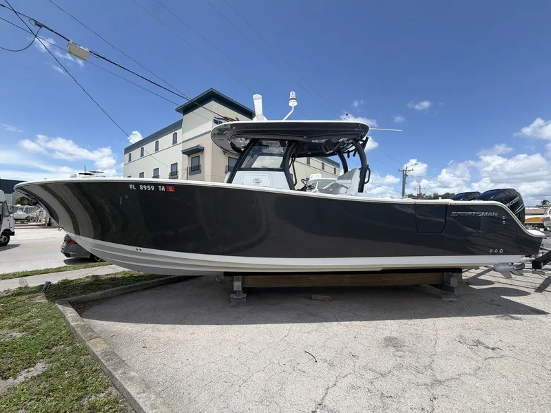 Slide: The Image of A 2021 Sportsman Open 322 Center Console boat is parked. It features a sleek, dark hull design. - 8