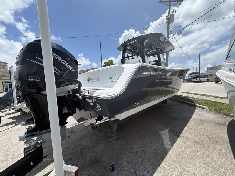 Slide: The Image of A 2021 Sportsman Open 322 Center Console boat on a trailer under a blue sky. - 5