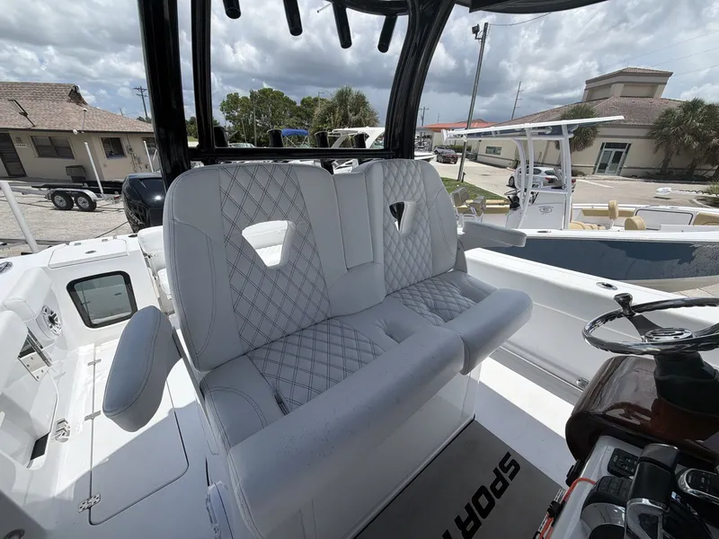 Slide: The Image of The 2021 Sportsman Open 322 Center Console features luxurious padded seating and a modern helm station. - 11
