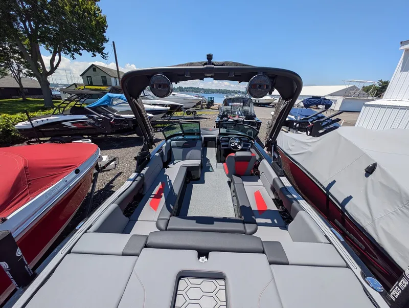 Slide: The Image of The image shows a 2025 MasterCraft NXT 23 boat with gray and red seating. - 5