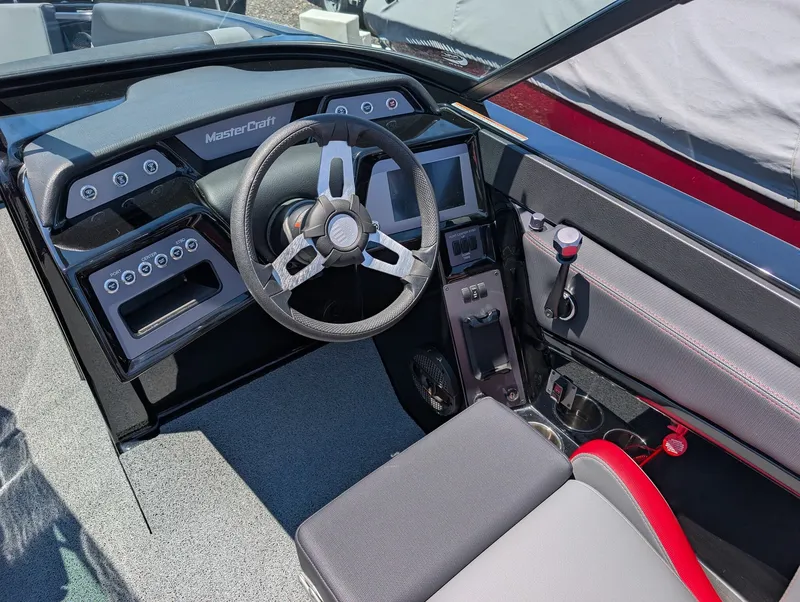 Slide: The Image of The image shows the cockpit of a 2025 MasterCraft NXT 23 with a modern steering wheel and digital display. - 8