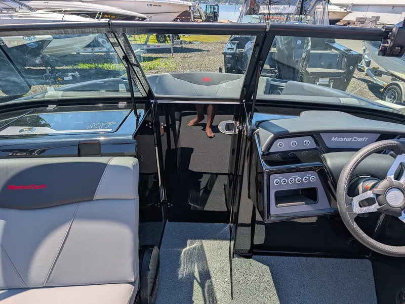 Slide: The Image of The image shows the cockpit of a 2025 MasterCraft NXT 23 boat with modern controls. - 10